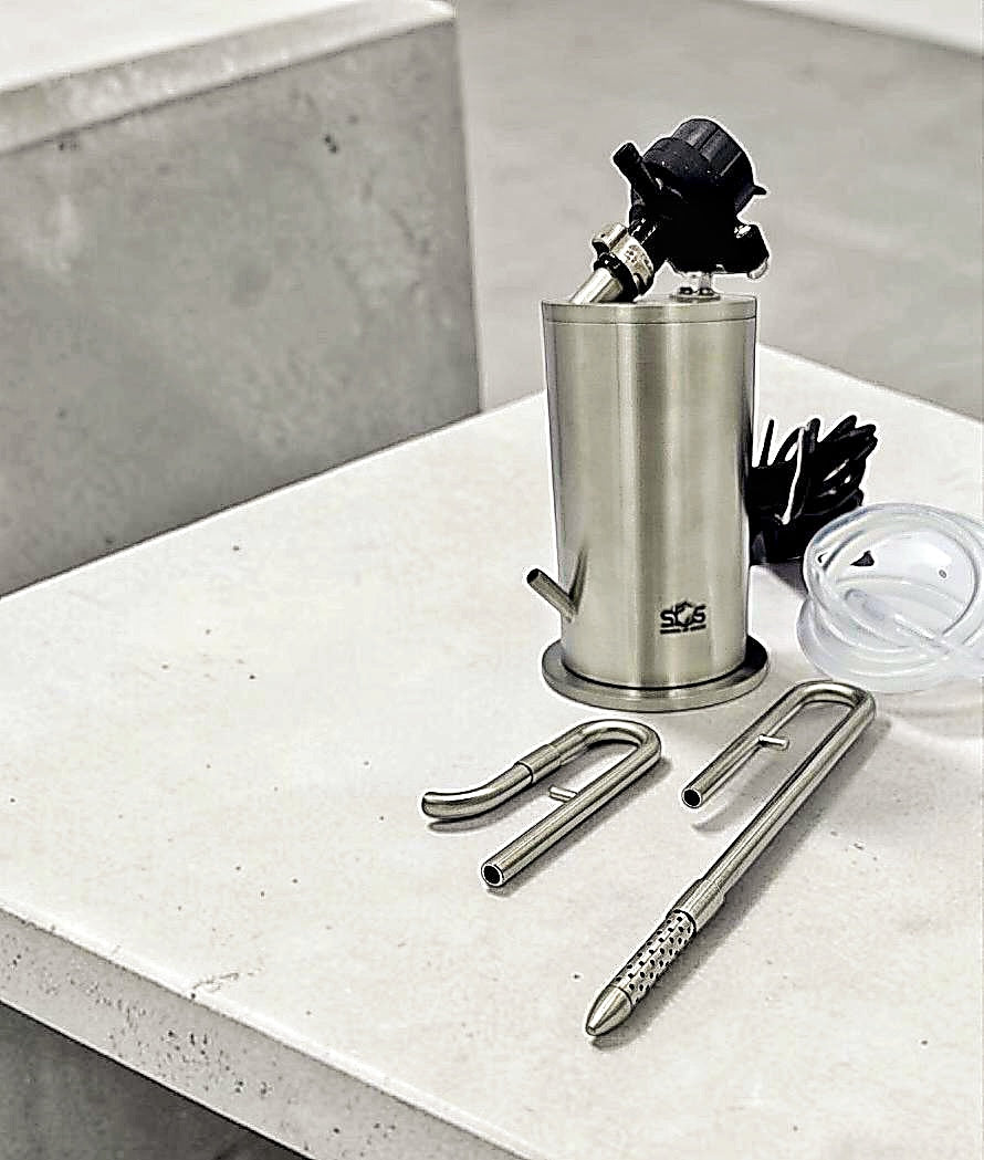 Metal canister with kitchen tools on a white surface