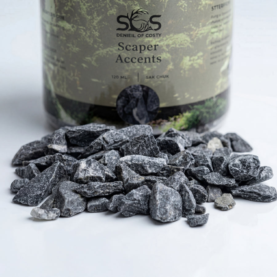 Decorative stones with a bottle labeled 'Scaper Accents' on a white background