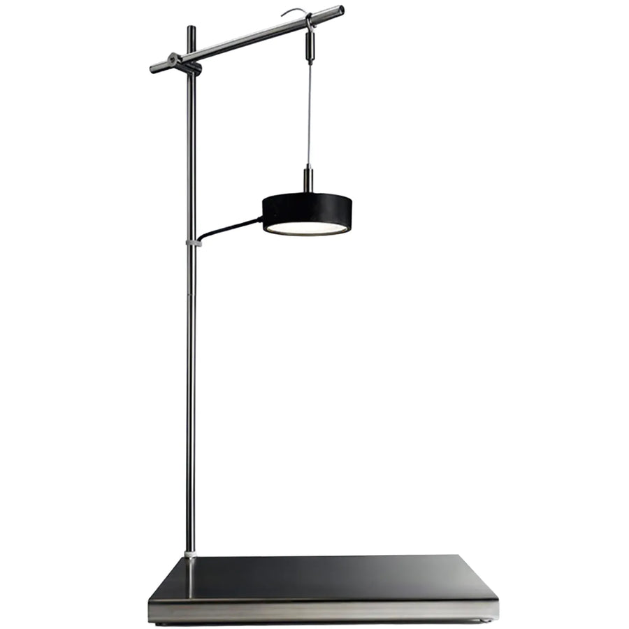 Modern floor lamp with black shade and metal arm on a white background